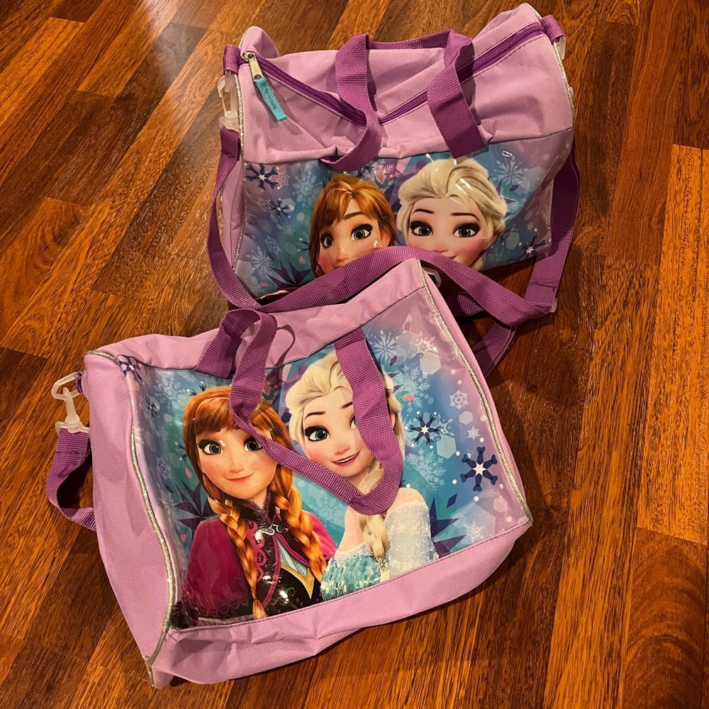 Two matching Let it Go duffel bags